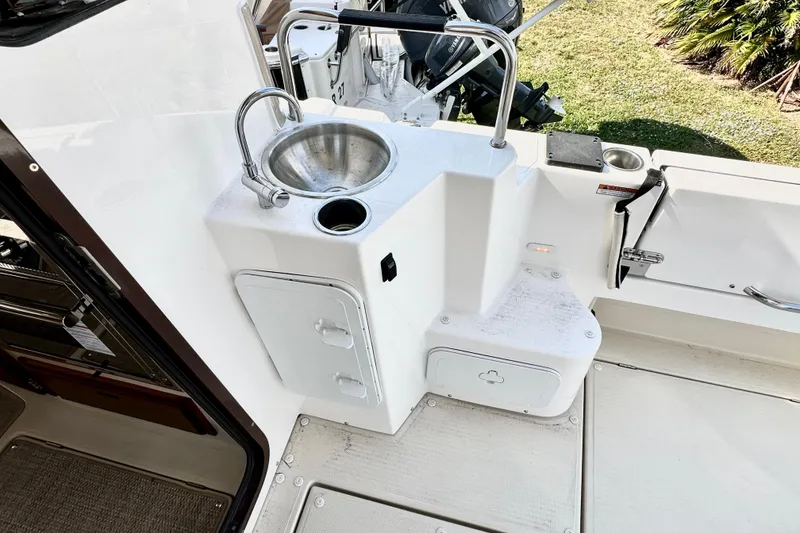 Slide: The Image of 2026 Ranger Tugs R-31 CB boat cockpit with sink and storage compartments. - 43