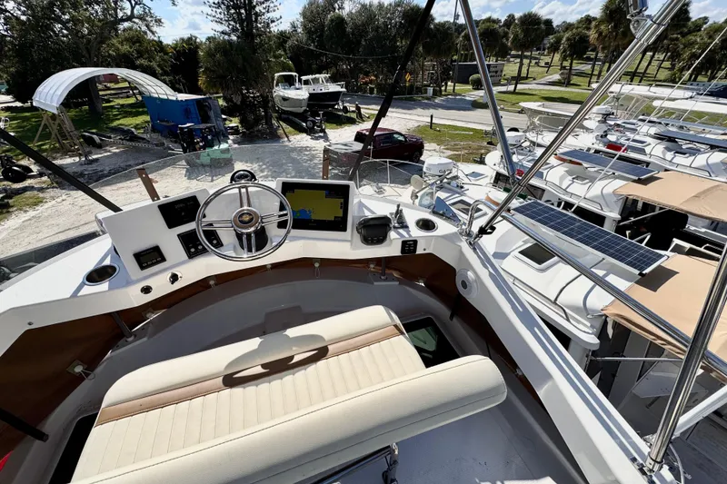 Slide: The Image of 2026 Ranger Tugs R-31 CB helm with modern controls and scenic marina view. - 47
