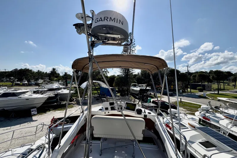 Slide: The Image of 2026 Ranger Tugs R-31 CB boat with Garmin equipment, docked under a clear blue sky. - 48