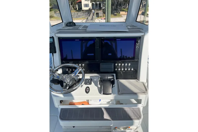 Slide: The Image of Helm of 2022 Costa Custom Boats 264 with dual screens and modern controls. - 14