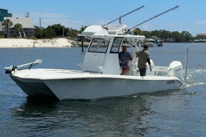 Slide: The Image of 2022 Costa Custom Boats 264 cruising on a sunny day near the shore. - 18