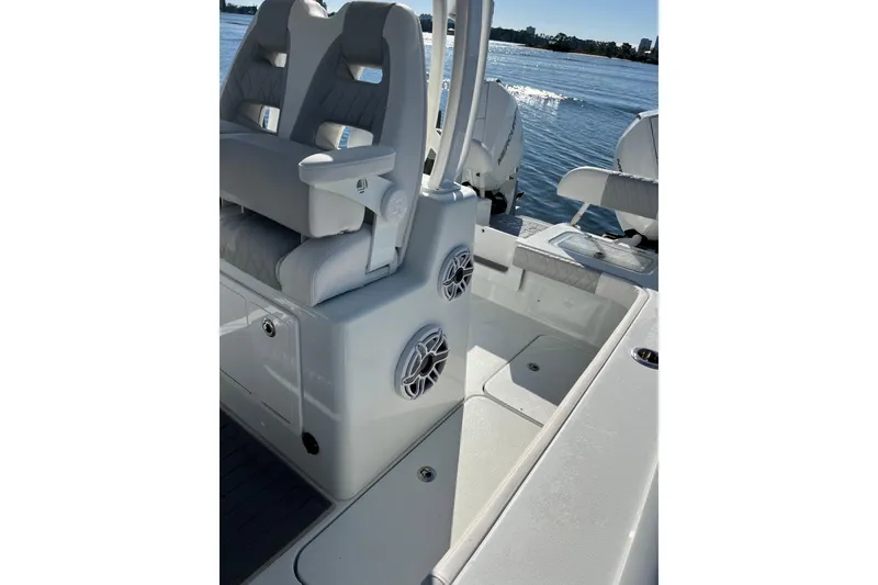 Slide: The Image of 2022 Costa Custom Boats 264 interior with seating and speakers on a sunny day. - 21