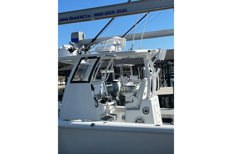 Slide: The Image of 2022 Costa Custom Boats 264, sleek design, docked at marina under clear blue sky. - 3