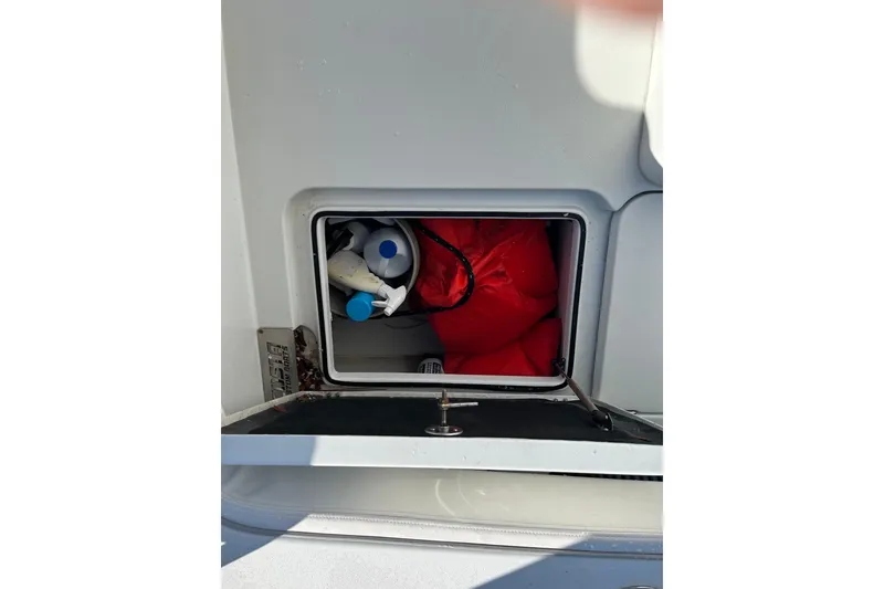 Slide: The Image of Storage compartment on 2022 Costa Custom Boats 264, containing life jackets and supplies. - 9