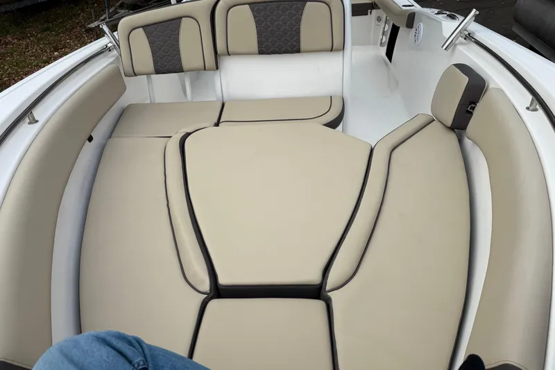 Slide: The Image of 2022 Tidewater 232 SS boat interior with beige cushioned seating. - 2
