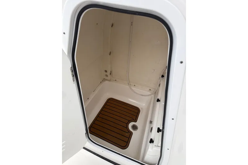 Slide: The Image of 2022 Tidewater 232 SS boat with outboard motor, parked on asphalt. - 8