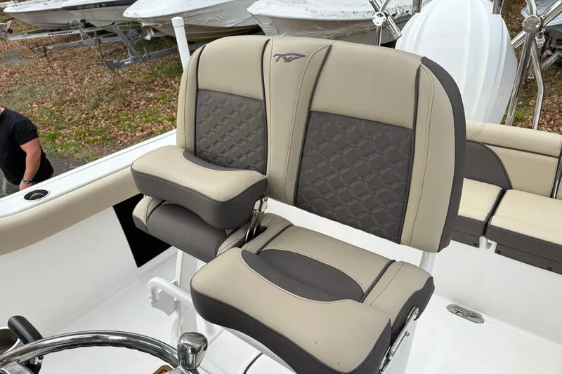 Slide: The Image of 2022 Tidewater 232 SS boat with beige seating and covered helm station. - 9