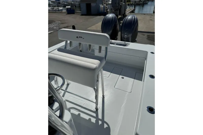 Slide: The Image of 2026 Contender 25 Tournament boat interior with dual engines at a marina. - 2