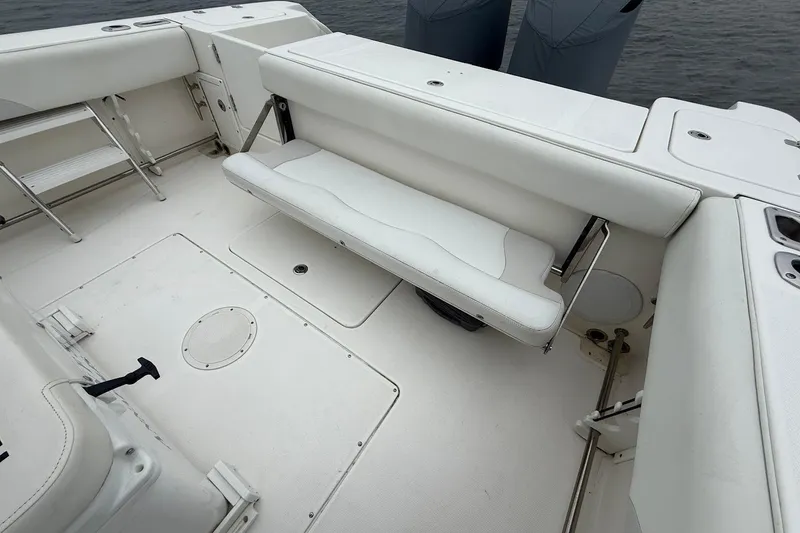 Slide: The Image of 2013 Edgewater 318CC boat interior with white seating and storage compartments. - 13