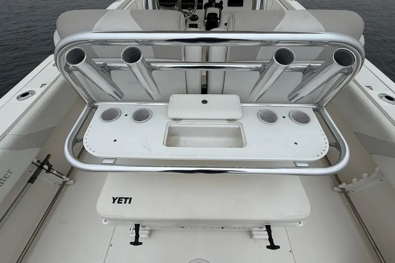 Slide: The Image of 2013 Edgewater 318CC boat with rod holders and YETI cooler on deck. - 16