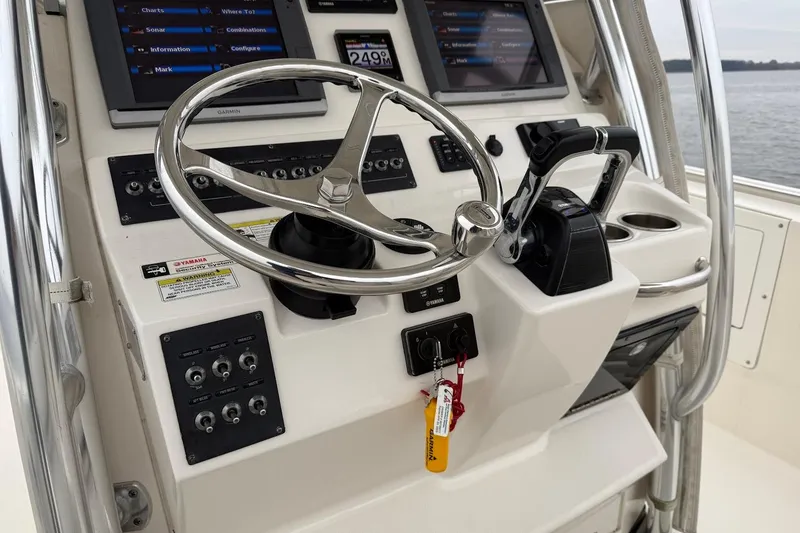 Slide: The Image of Edgewater 318CC 2013 boat console with steering wheel and navigation controls. - 22