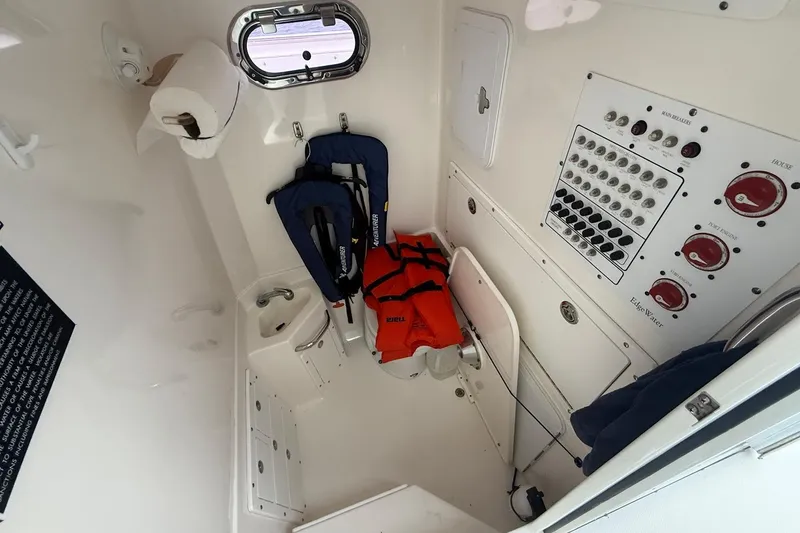 Slide: The Image of Interior of 2013 Edgewater 318CC boat with life jackets and control panel. - 26