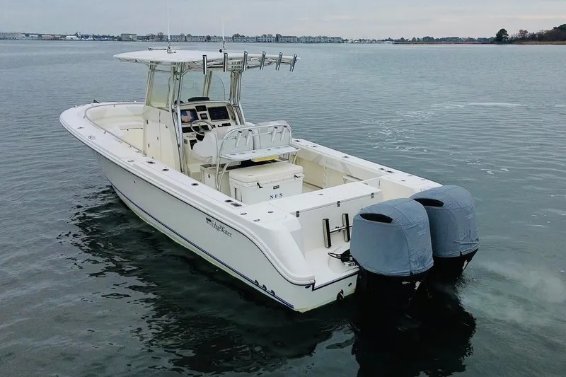 Slide: The Image of 2013 Edgewater 318CC boat with dual engines on calm water. - 5