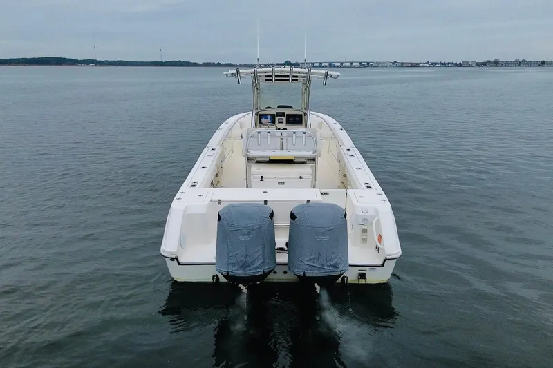 Slide: The Image of 2013 Edgewater 318CC boat with dual engines on calm water. - 6