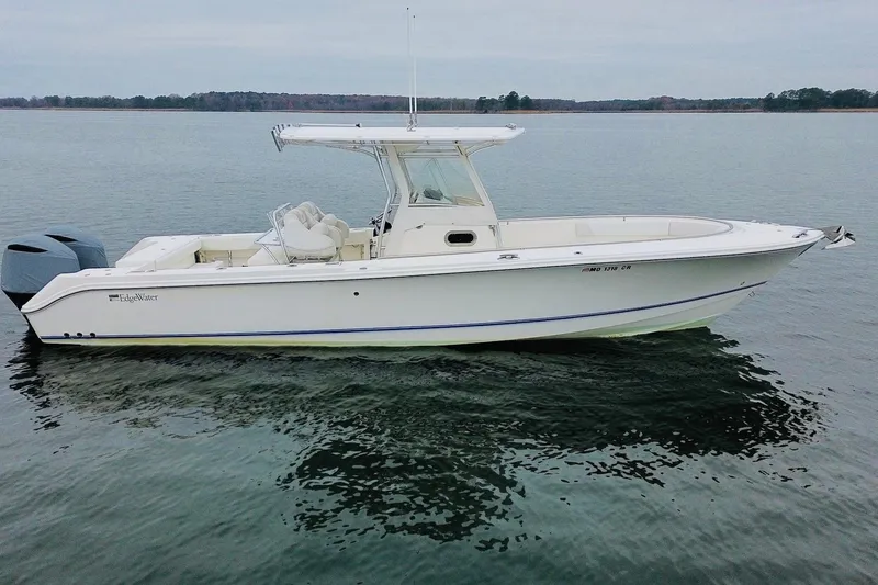 Slide: The Image of 2013 Edgewater 318CC boat on calm water, side view. - 8