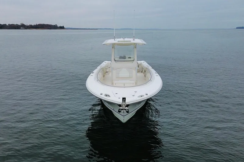 Slide: The Image of 2013 Edgewater 318CC boat on calm water, front view. - 9