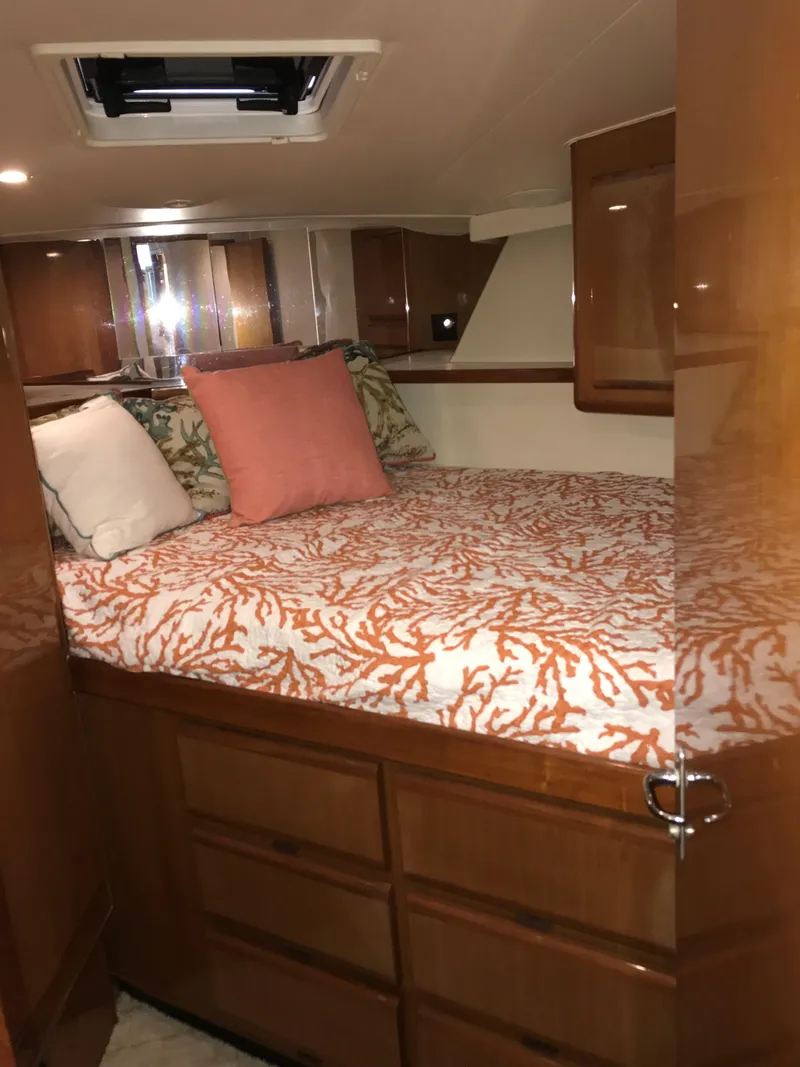 Slide: The Image of Cozy bedroom in 2000 Viking 50 Convertible yacht with coral-patterned bedding. - 15