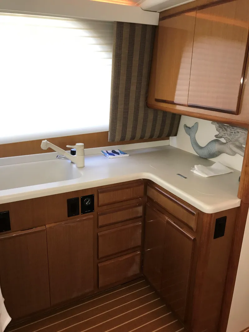 Slide: The Image of 2000 Viking 50 Convertible yacht kitchen with wooden cabinets and modern fixtures. - 19