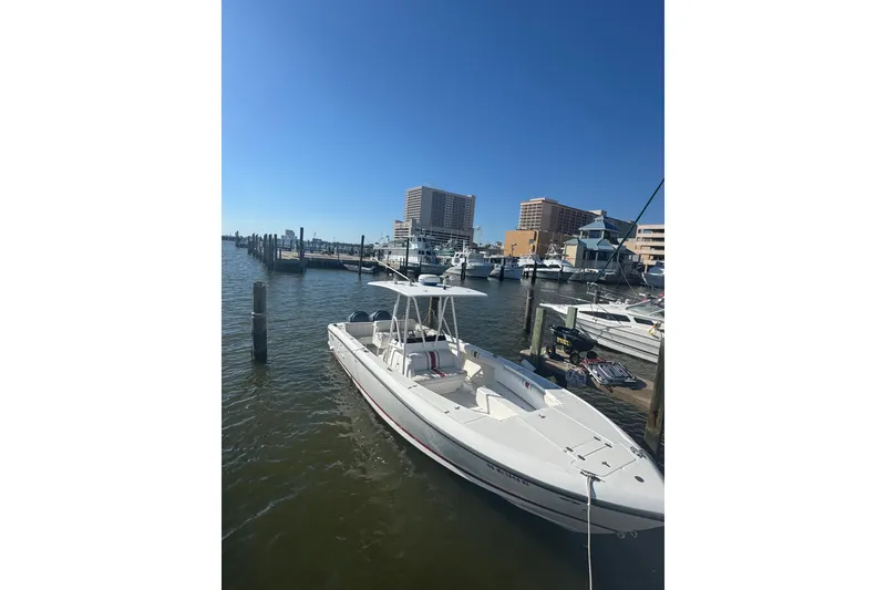 Slide: The Image of Docked Viking 50 Convertible yacht, 2000 model, in a marina with cityscape background. - 20