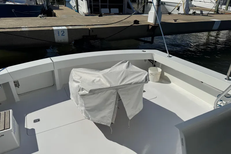 Slide: The Image of Viking 50 Convertible 2000 boat deck with covered equipment and dock view. - 25