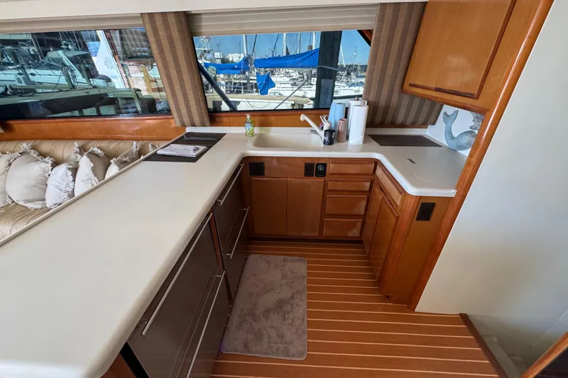 Slide: The Image of Interior of 2000 Viking 50 Convertible yacht with modern kitchen and marina view. - 27