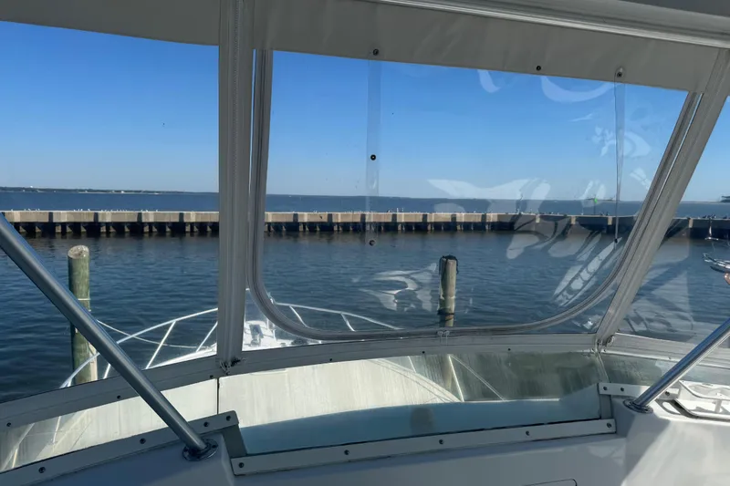Slide: The Image of View from a 2000 Viking 50 Convertible yacht, overlooking a calm marina. - 32
