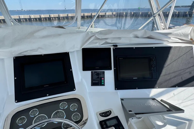 Slide: The Image of Helm of 2000 Viking 50 Convertible yacht with Garmin displays and ocean view. - 36