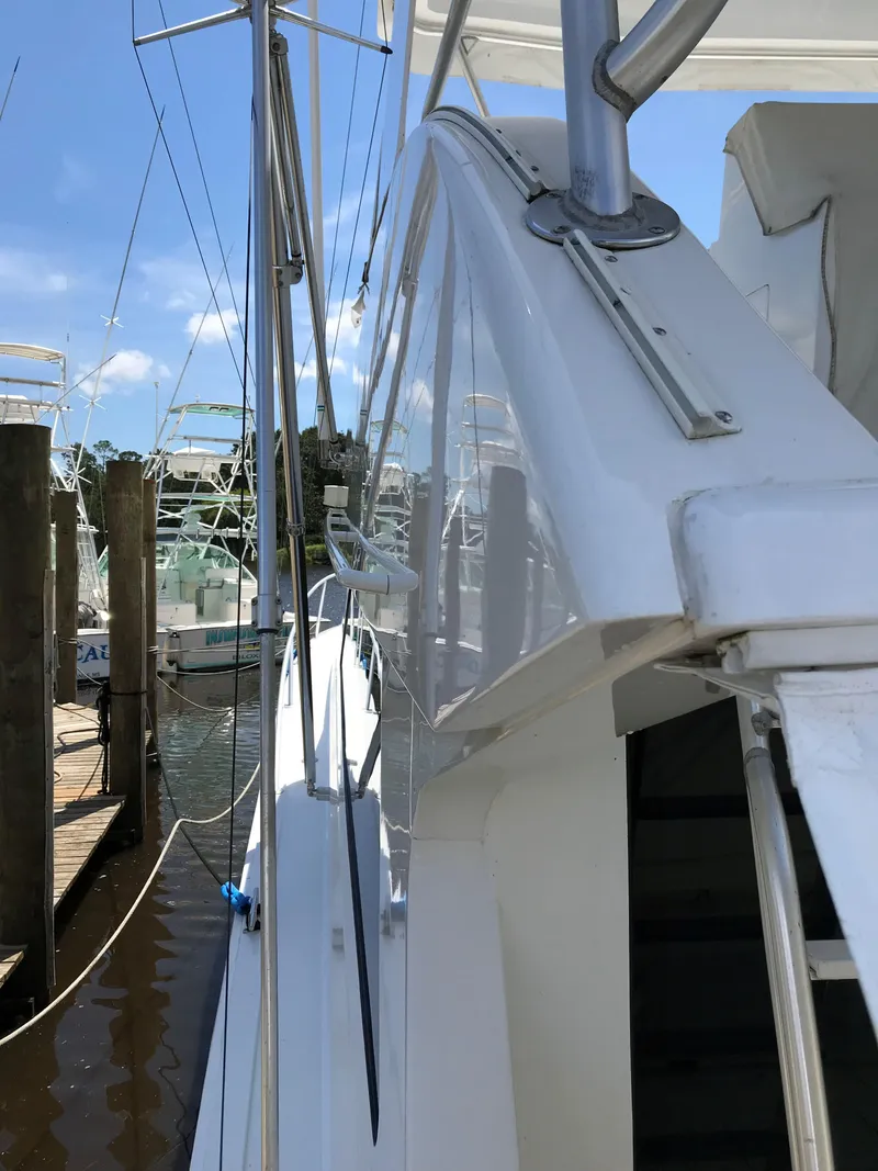 Slide: The Image of 2000 Viking 50 Convertible yacht docked, showcasing sleek design and polished exterior. - 7