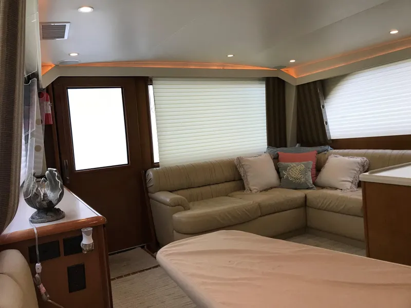 Slide: The Image of Interior of 2000 Viking 50 Convertible yacht with beige leather seating and modern decor. - 8