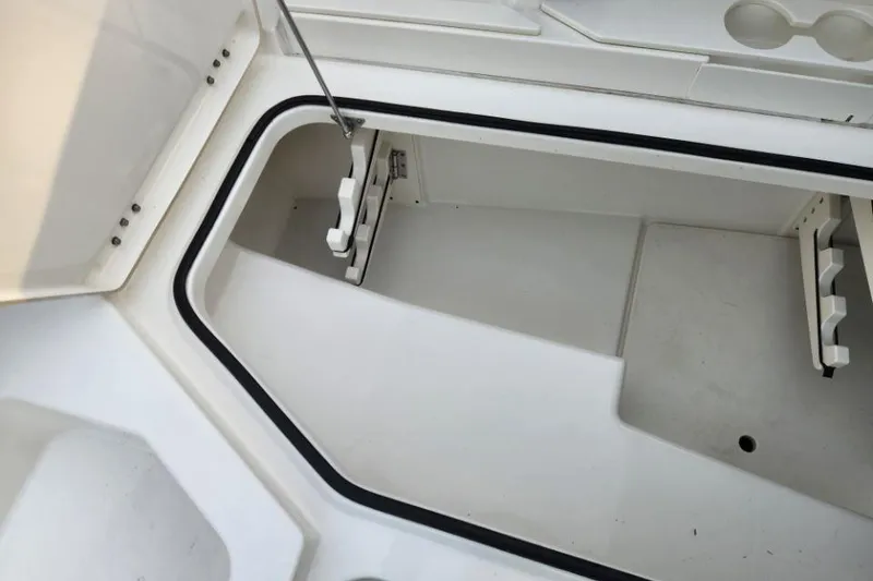 Slide: The Image of 2024 World Cat 260 DC-X storage compartment, open lid, white interior. - 12