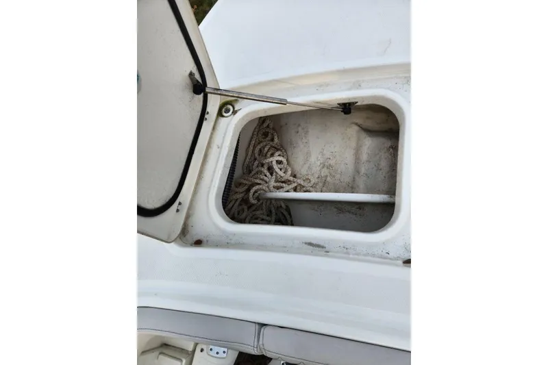 Slide: The Image of Open storage compartment on 2024 World Cat 260 DC-X boat with coiled rope inside. - 15