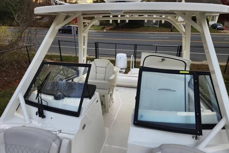 Slide: The Image of 2024 World Cat 260 DC-X boat interior with seating and windshield view. - 16