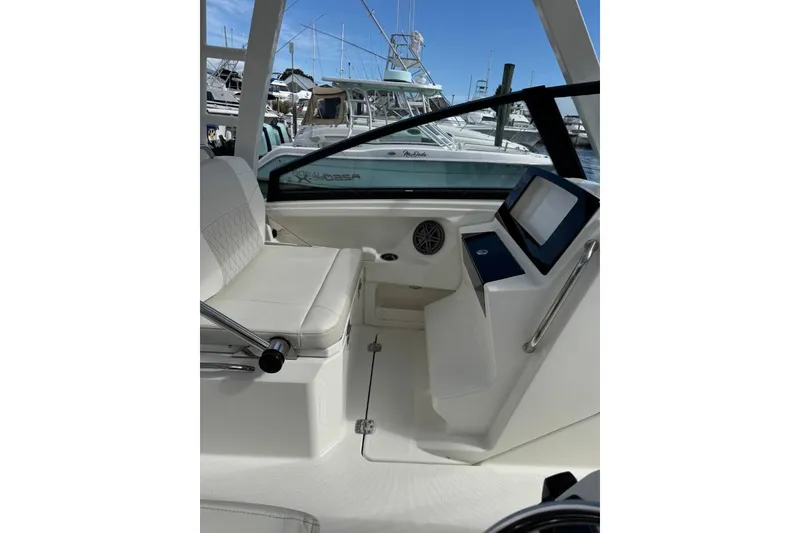 Slide: The Image of 2024 World Cat 260 DC-X boat interior with seating and control panel. - 19