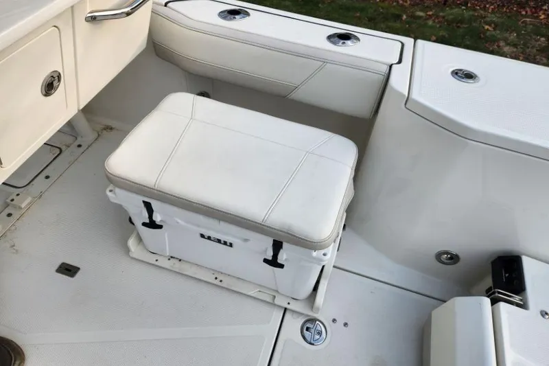 Slide: The Image of 2024 World Cat 260 DC-X boat interior with cushioned seating and storage. - 29