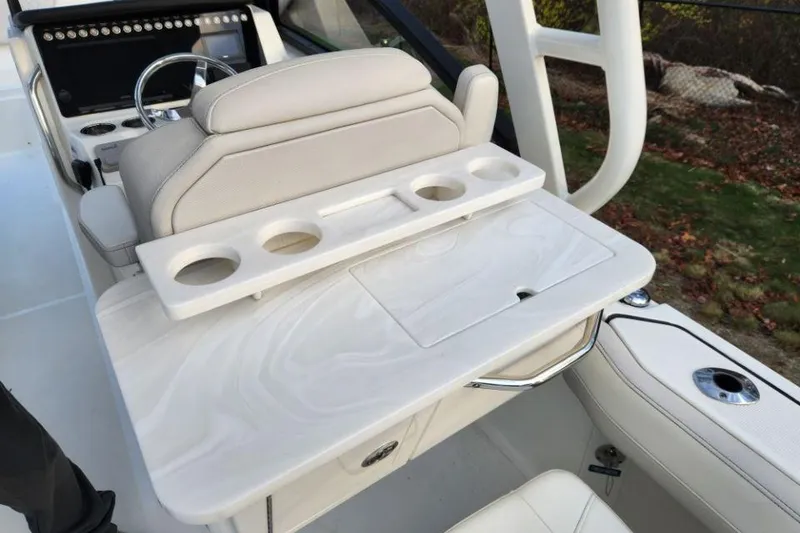 Slide: The Image of 2024 World Cat 260 DC-X boat interior with cup holders and seating area. - 30
