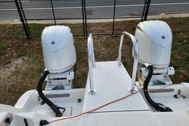 Slide: The Image of 2024 World Cat 260 DC-X boat with dual outboard motors and rear platform. - 32