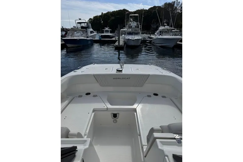 Slide: The Image of 2024 World Cat 260 DC-X boat interior at marina, surrounded by other boats. - 8