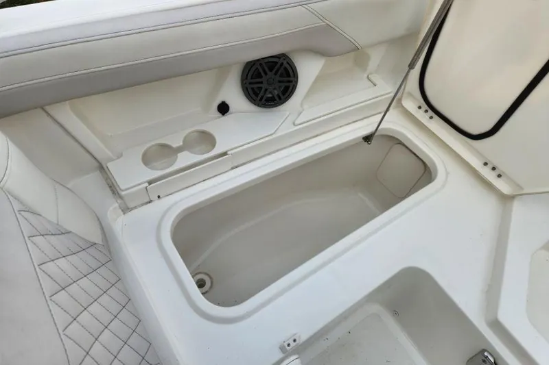 Slide: The Image of 2024 World Cat 260 DC-X boat interior with storage compartment and speaker. - 9