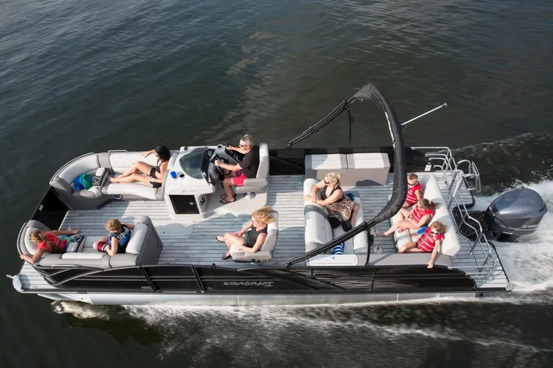 The Image of 2016 Starcraft MX 25 DL pontoon boat parked on grass, side view. - 0