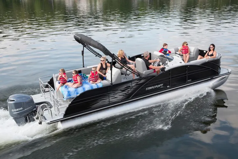 Slide: The Image of 2016 Starcraft MX 25 DL boat interior with beige seating and wooden flooring. - 2