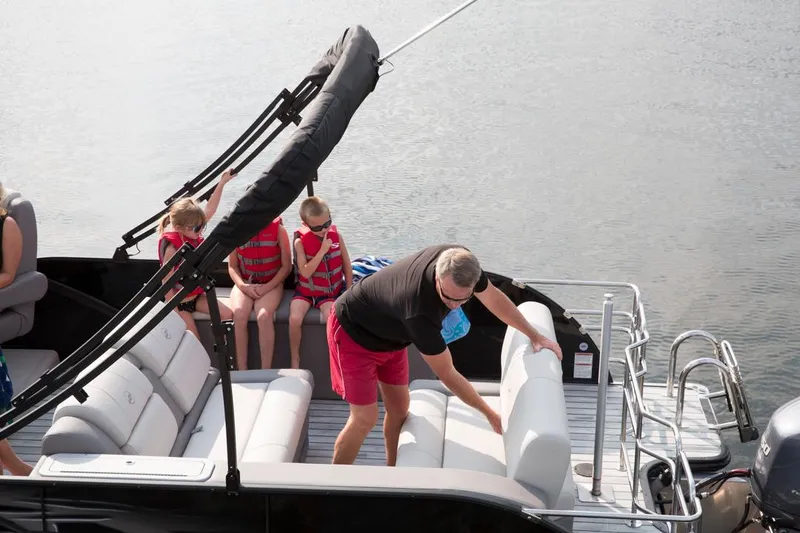 Slide: The Image of 2016 Starcraft MX 25 DL boat interior with cushioned seating and wooden flooring. - 3