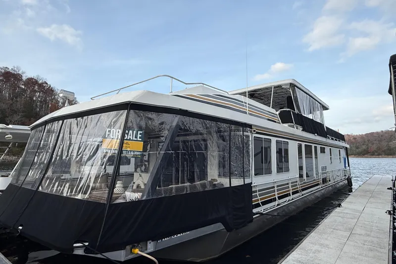 The Image of 2000 Stardust Cruisers houseboat for sale, docked on a serene lake. - 1
