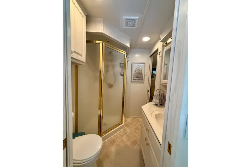 Slide: The Image of Bathroom interior of 2000 Stardust Cruisers houseboat with shower and vanity. - 11