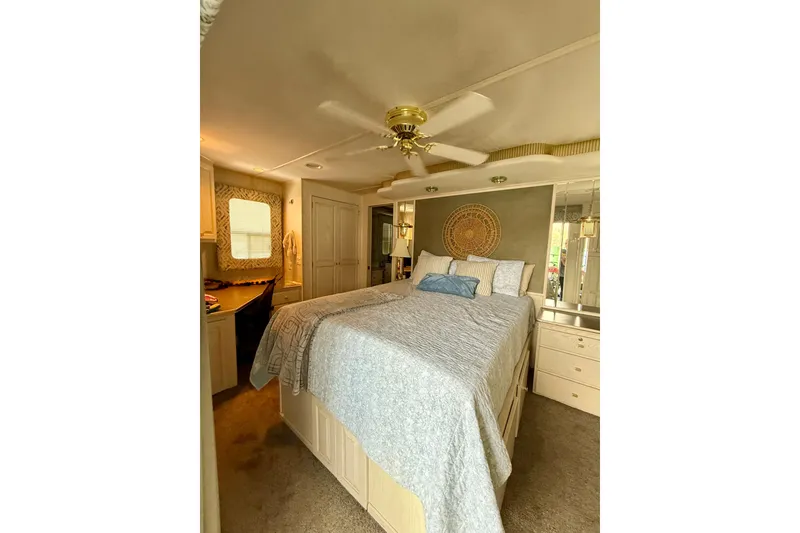 Slide: The Image of Luxurious bedroom interior of a 2000 Stardust Cruisers houseboat with elegant decor. - 14