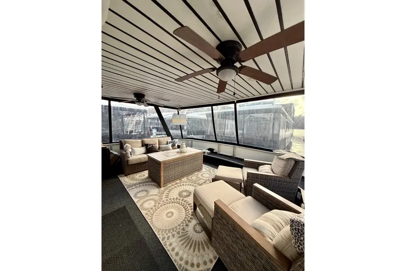 Slide: The Image of Luxurious 2000 Stardust Cruisers houseboat interior with cozy seating and ceiling fan. - 22
