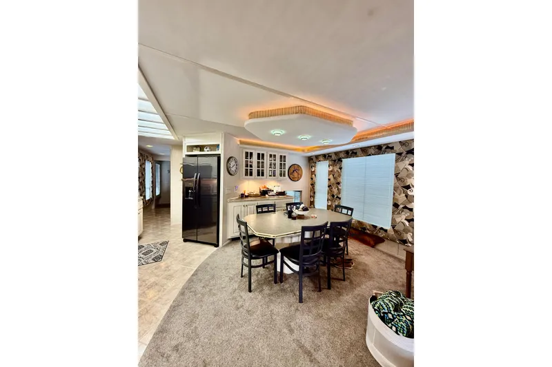 Slide: The Image of Luxurious 2000 Stardust Cruisers houseboat interior with modern kitchen and dining area. - 5