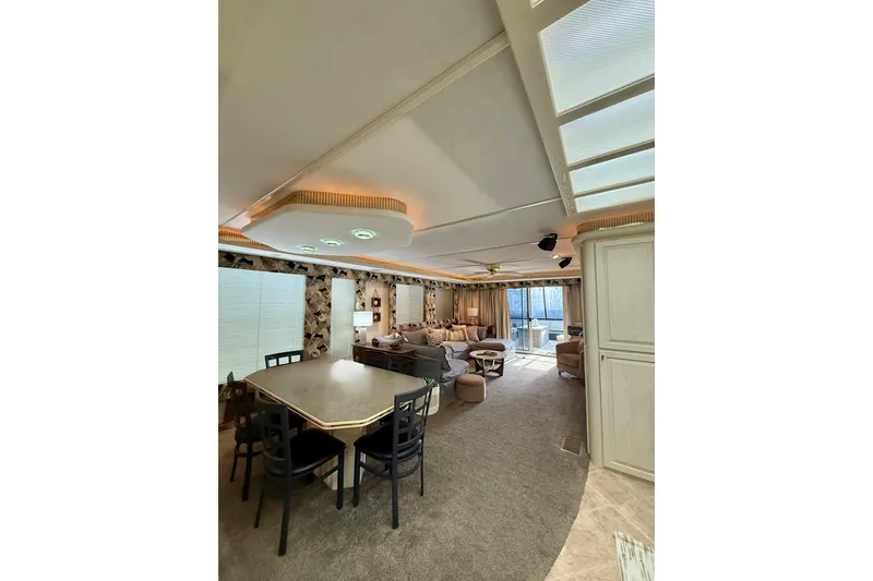 Slide: The Image of Luxurious 2000 Stardust Cruisers houseboat interior with dining area and cozy living space. - 6