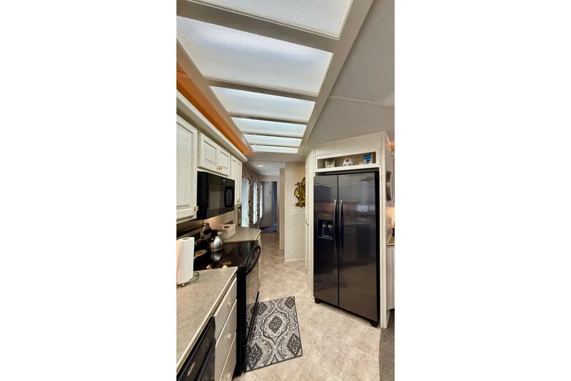 Slide: The Image of Modern kitchen interior of 2000 Stardust Cruisers houseboat with sleek appliances. - 8
