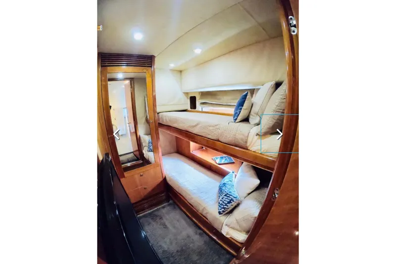 Slide: The Image of Interior of 2006 Sunseeker Predator 82 yacht with cozy bunk beds and wooden finish. - 14