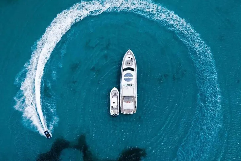 Slide: The Image of Aerial view of 2006 Sunseeker Predator 82 yacht with jet ski in turquoise water. - 7